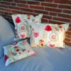 Outdoorkissen Winter: Herzen, Sterne & Tanne